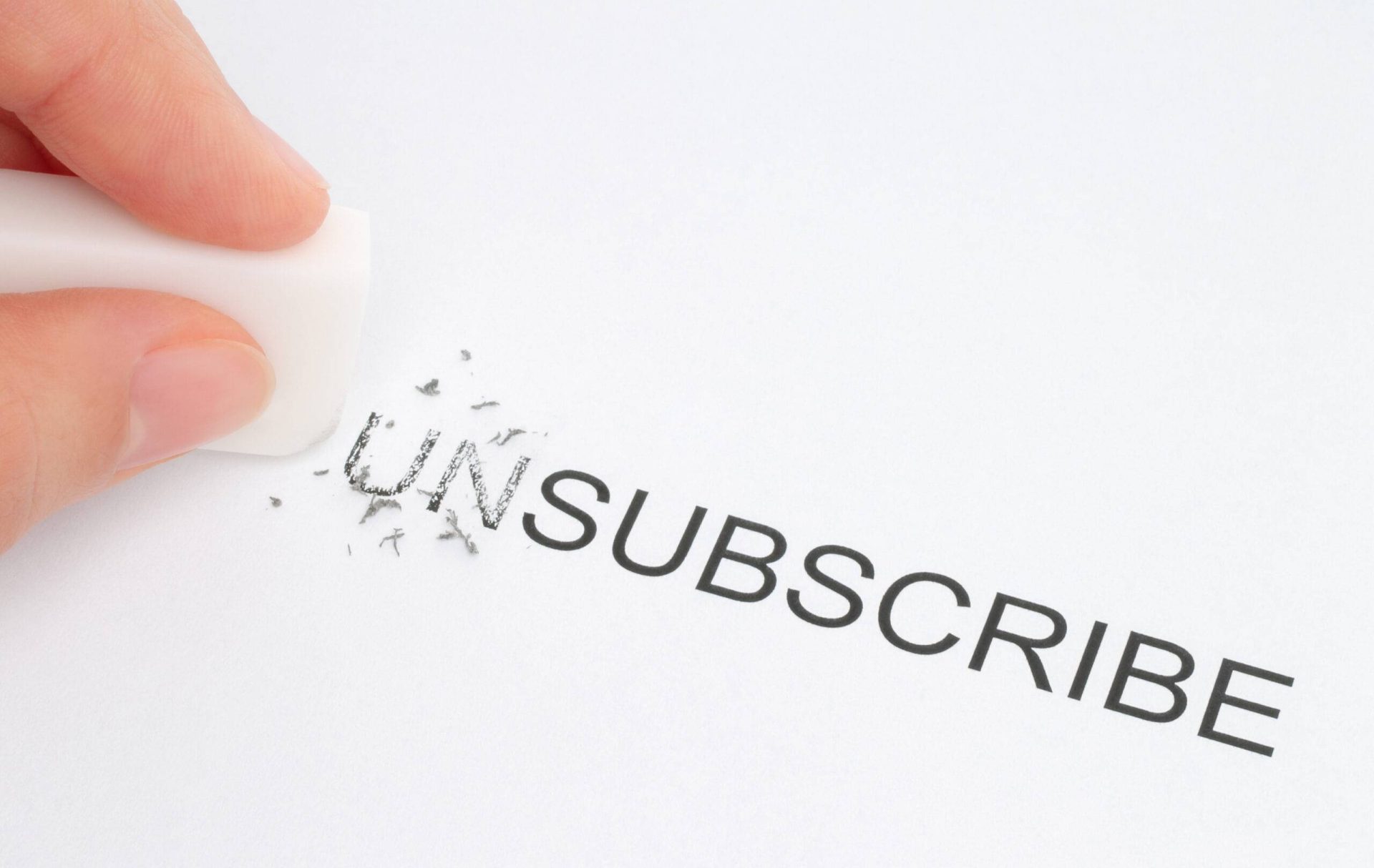 Hand erase part of the unsubscribe word close-up